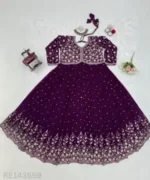 Woman wearing a Fox Georgette embroidered outfit at a festive event.